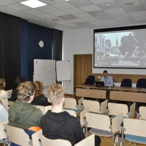 Powiększ obraz: studenci siedzą w sali konferencyjnej przed wykładowcą